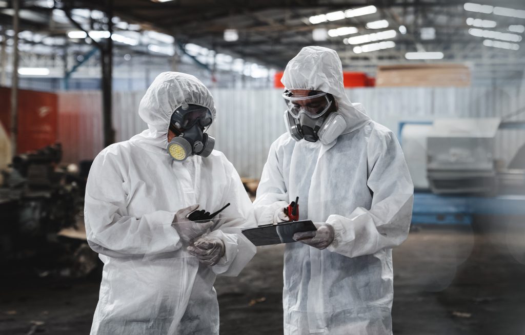 Two workers in protective suits